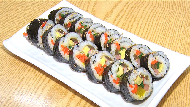 Kimbap is a classic Korean favorite! It's made by wrapping rice and a variety of ingredients in a big sheet of nori. Kimbap is a tasty, well-balanced dish.