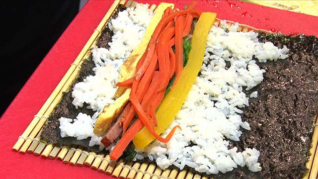 One specialty store fills its kimbap with imitation crab meat, ham, fried egg strips, pickled radish, spinach, and carrot.