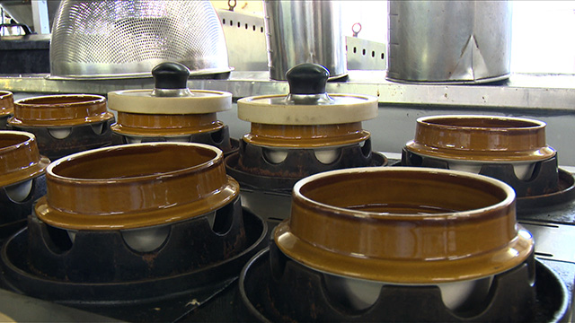 The rice is cooked in individual ceramic pots over direct heat.