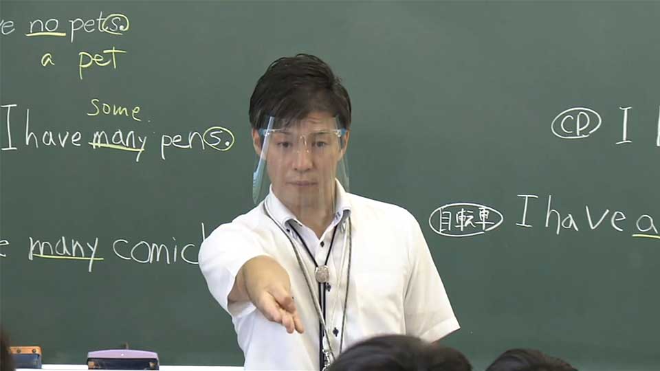 Kawano teaching English with face shield