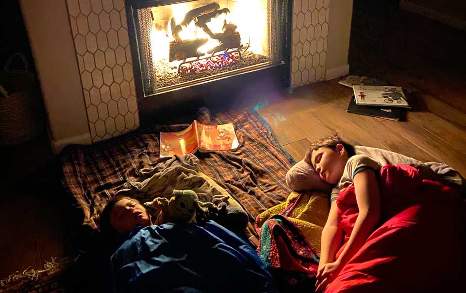 Boles's kids sleeping by fireplace in the dark