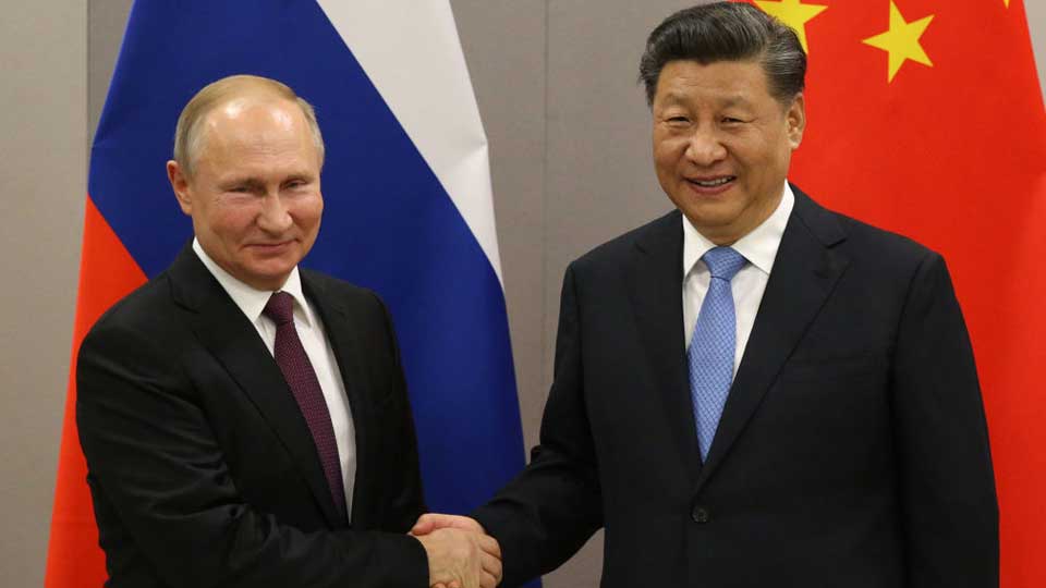 Russian President Vladimir Putin shaking hands with Chinese President Xi Jinping during their bilateral meeting on November 13, 2019 in Brasilia, Brazil.