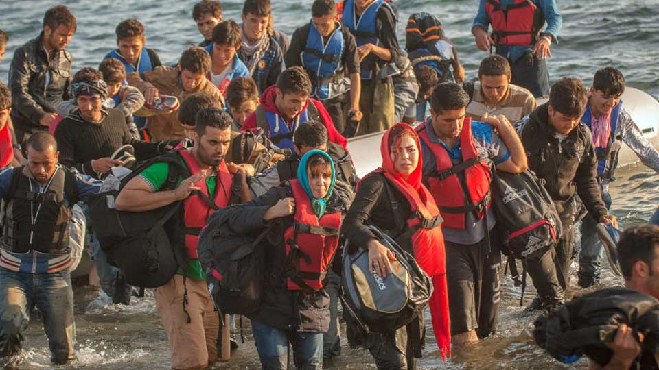 Refugees land on the island of Lesvos, Greece, after crossing the Aegean Sea on September 17, 2015.