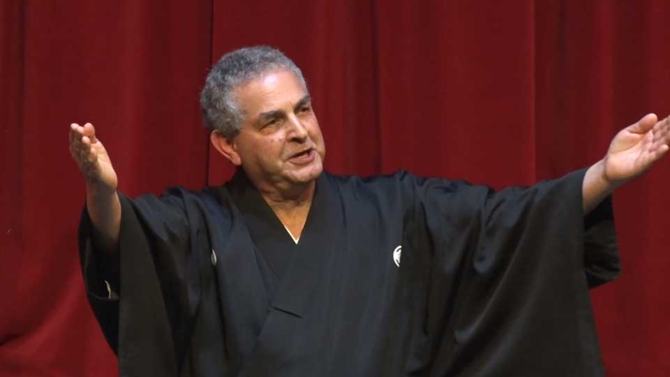 Laurence Kominz greets the audience with a traditional kabuki-style announcement.