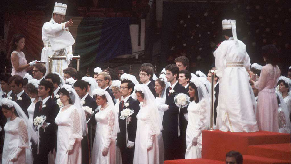 Moon Sun Myung, founder of the Unification Church, blesses more than 4,000 followers after their mass wedding in New York, 1982. 