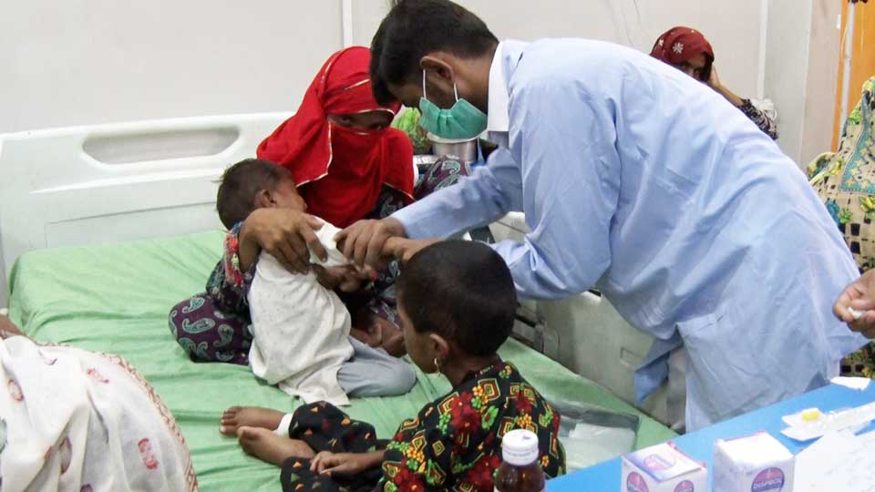 Doctors treating sick children at Gulam Muhammad Mahar Medical Hospital in Sukkur.