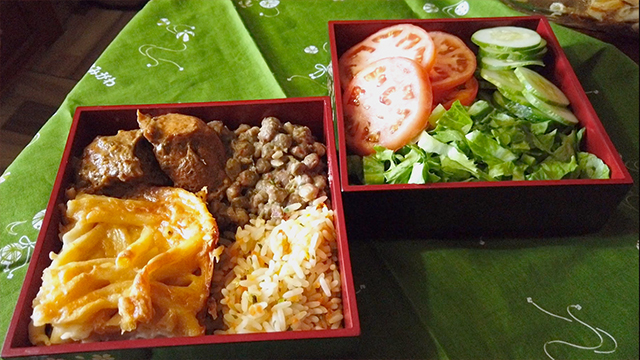 A delicious Trinidadian Sunday lunch bento of stewed chicken, stewed beans, macaroni pie, vegetable fried rice, and salad!