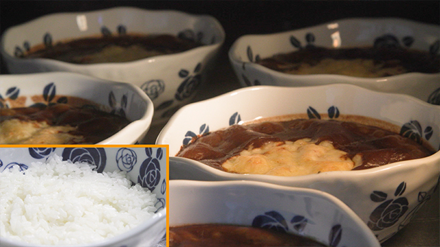 The rich curry is poured over local rice in an Arita ware bowl. It’s then topped with cheese and baked in an oven until it’s done.