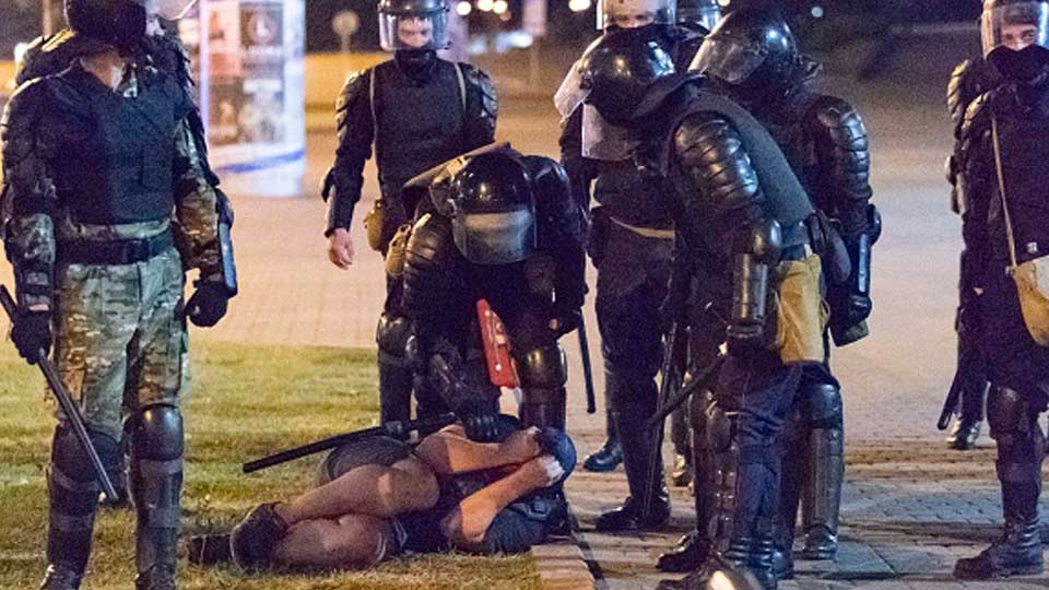 Riot police surround a protestor in Minsk
