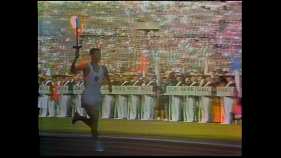 Sakai Yoshinori, the last runner, running with the flame